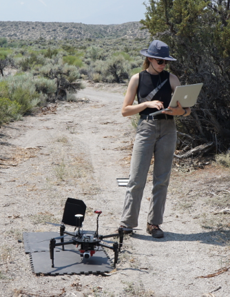 Paulina in the field working with a drone.